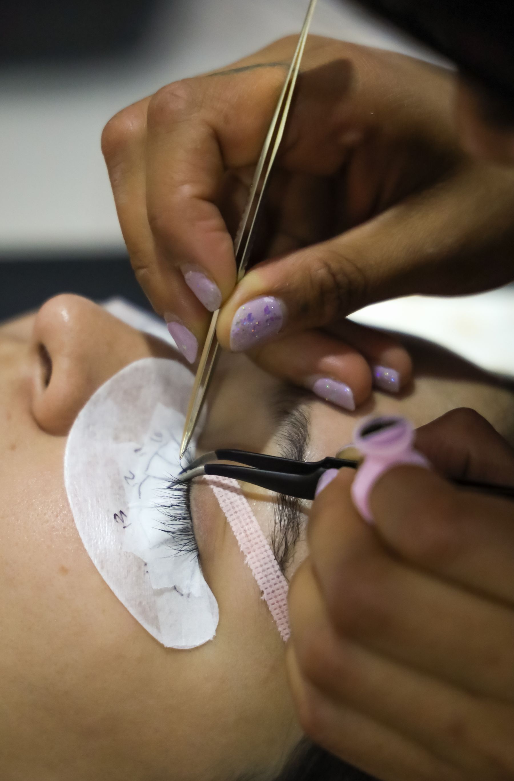 Close-up of eyelash extension application